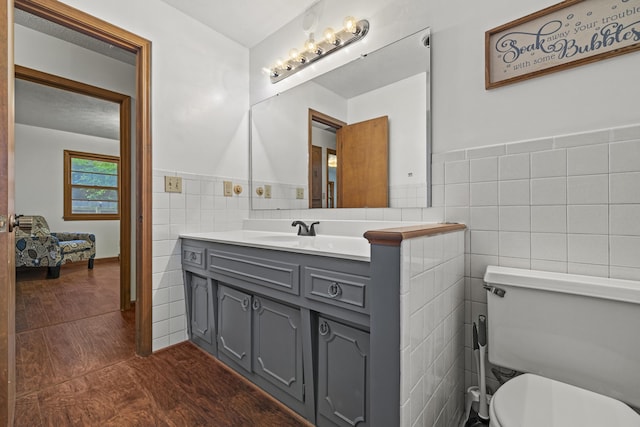716 S Rogers Ave, Springfield, MO 65804 - bathroom featuring tile walls, vanity, wainscoting, and wood finished floors