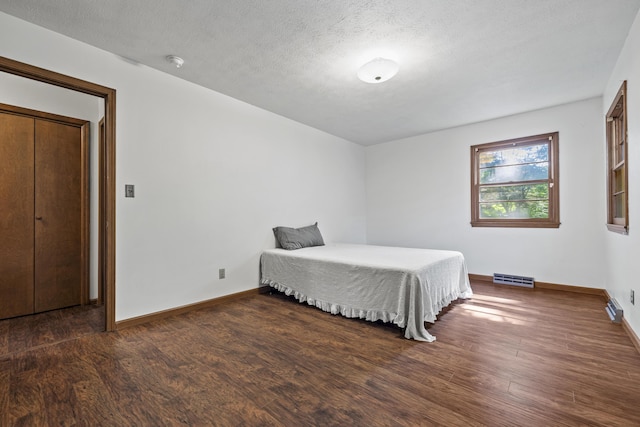 716 S Rogers Ave, Springfield, MO 65804 - bedroom featuring wood finished floors and a textured ceiling