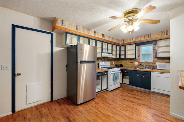 1111 S Lone Pine Ave, Springfield, MO 65804 - kitchen with white appliances, light wood finished floors, a textured ceiling, ceiling fan, and tasteful backsplash