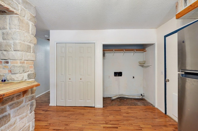 1111 S Lone Pine Ave, Springfield, MO 65804 - washroom with electric dryer hookup, wood finished floors, and a textured ceiling