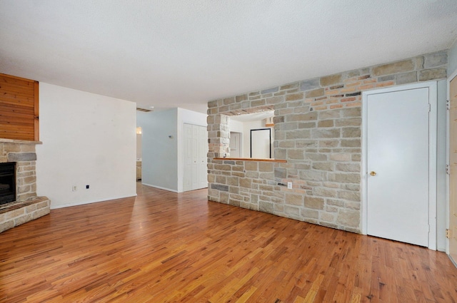 1111 S Lone Pine Ave, Springfield, MO 65804 - unfurnished living room featuring a fireplace and wood finished floors