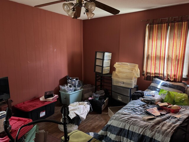 806 Lathrop Ave, Ava, MO 65608 - bedroom featuring wood finished floors, ceiling fan, and wooden walls