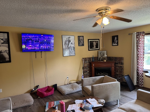806 Lathrop Ave, Ava, MO 65608 - living room with wood finished floors, ceiling fan, a textured ceiling, and a brick fireplace