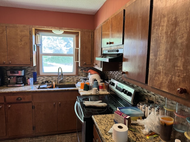 806 Lathrop Ave, Ava, MO 65608 - kitchen with electric stove, under cabinet range hood, decorative backsplash, light countertops, and a textured ceiling