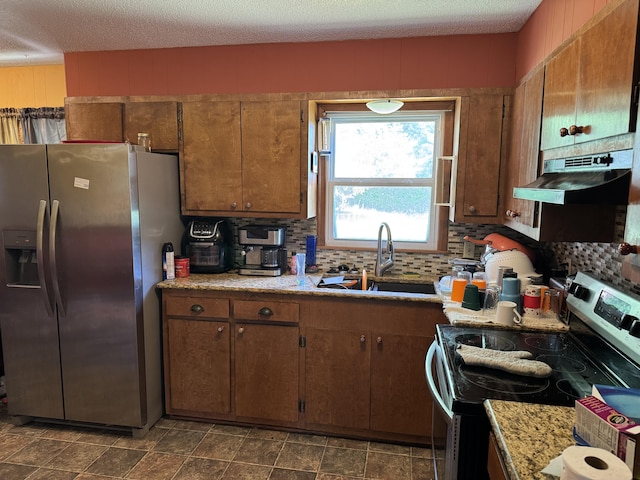 806 Lathrop Ave, Ava, MO 65608 - kitchen featuring appliances with stainless steel finishes, decorative backsplash, light countertops, under cabinet range hood, and a textured ceiling