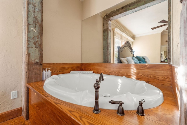 120 N 4th St, Branson, MO 65616 - bathroom with crown molding, ceiling fan, a tub to relax in, and a textured wall