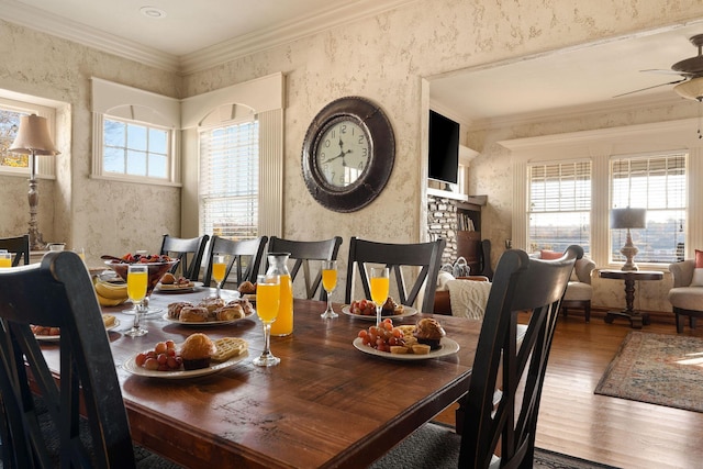 120 N 4th St, Branson, MO 65616 - dining area featuring wood finished floors, a ceiling fan, ornamental molding, and a fireplace