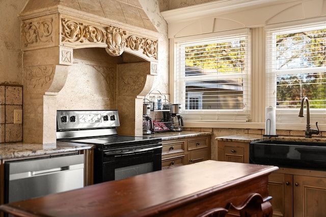 120 N 4th St, Branson, MO 65616 - kitchen with electric stove, dishwasher, brown cabinetry, and healthy amount of natural light