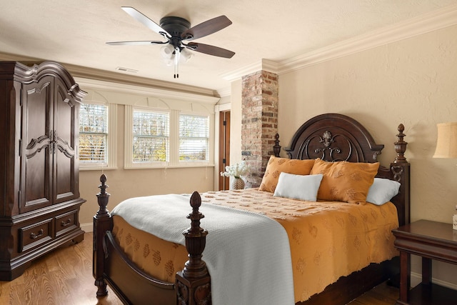 120 N 4th St, Branson, MO 65616 - bedroom with wood finished floors, ornamental molding, and a ceiling fan