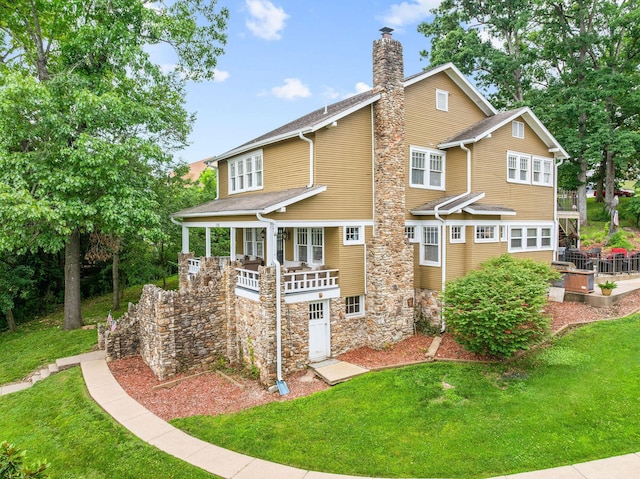 120 N 4th St, Branson, MO 65616 - back of property featuring a lawn, a chimney, and stone siding