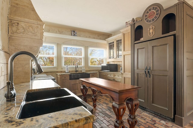 120 N 4th St, Branson, MO 65616 - kitchen featuring brick flooring, glass insert cabinets, and light stone countertops