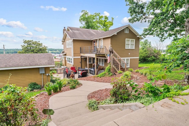 120 N 4th St, Branson, MO 65616 - back of house with stairs, an outdoor living space, a patio, a wooden deck, and a chimney