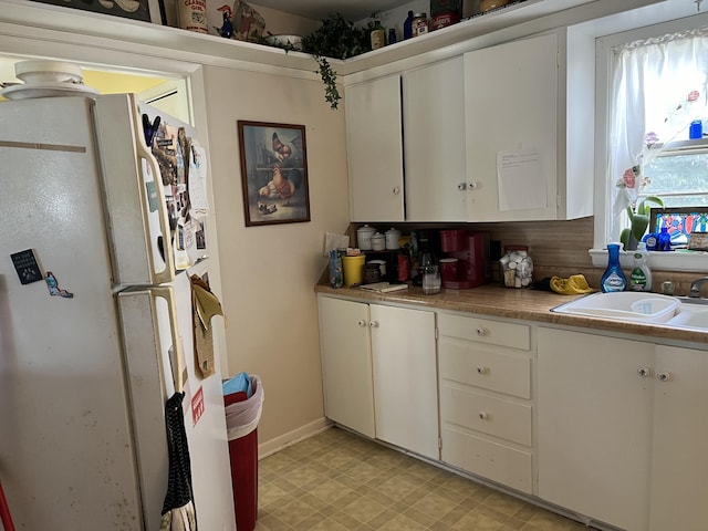 424 W Park St, Seymour, MO 65746 - kitchen featuring freestanding refrigerator, light countertops, and white cabinets