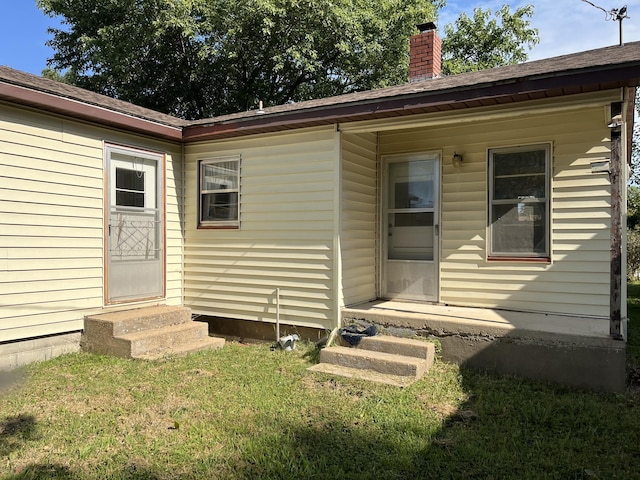 424 W Park St, Seymour, MO 65746 - doorway to property with a chimney, a lawn, and a shingled roof