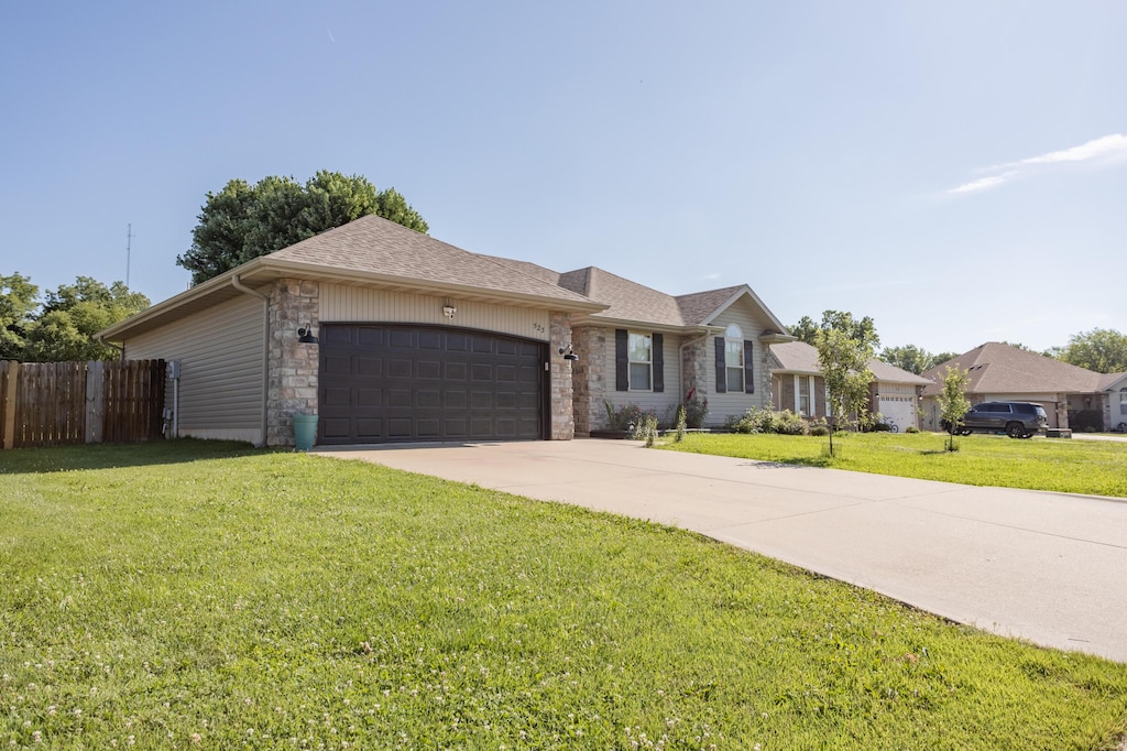 523 W Logan St, Republic, MO 65738 - single story home featuring an attached garage, driveway, and stone siding