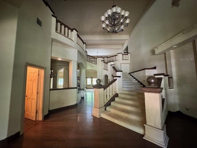 2665 W Blakey St, Springfield, MO 65810 - entryway featuring a towering ceiling, stairs, a chandelier, hardwood / wood-style floors, and arched walkways