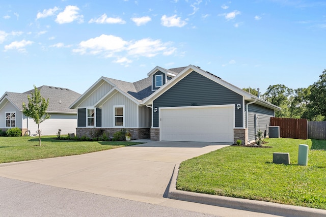 3891 N Spring Branch Ave, Springfield, MO 65803 - view of front of house with an attached garage, stone siding, concrete driveway, board and batten siding, and a shingled roof