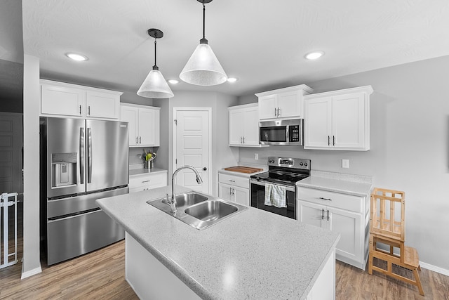 3891 N Spring Branch Ave, Springfield, MO 65803 - kitchen featuring appliances with stainless steel finishes, white cabinets, recessed lighting, light wood-style flooring, and pendant lighting