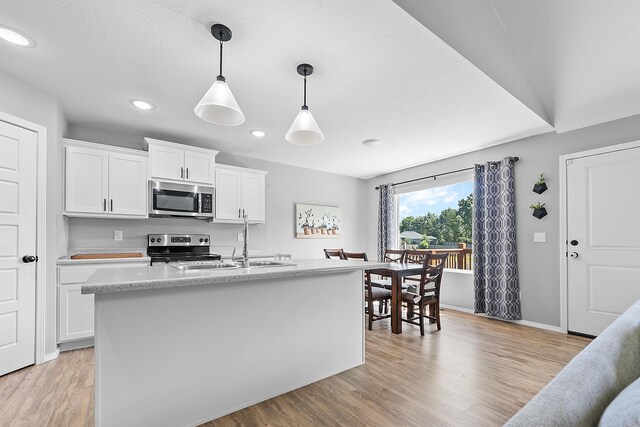 3891 N Spring Branch Ave, Springfield, MO 65803 - kitchen with stainless steel appliances, light wood-type flooring, white cabinets, recessed lighting, and pendant lighting