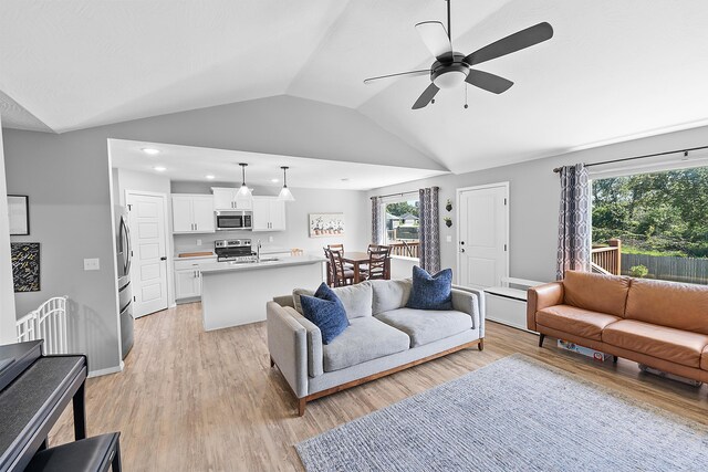 3891 N Spring Branch Ave, Springfield, MO 65803 - living area with vaulted ceiling, ceiling fan, light wood finished floors, and recessed lighting