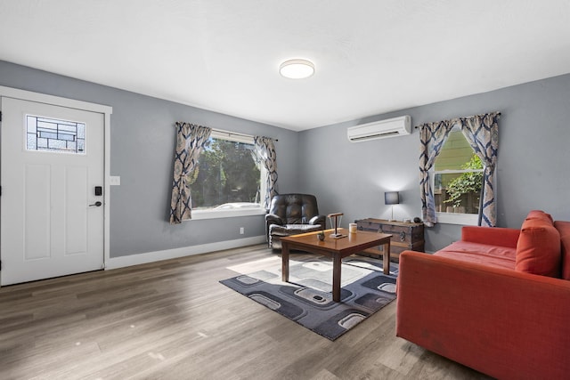 2019 N Rogers Ave, Springfield, MO 65803 - living area featuring an AC wall unit and wood finished floors