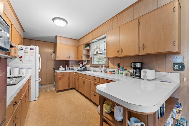 25720 Hillcrest Dr, Shell Knob, MO 65747 - kitchen with open shelves, a peninsula, light countertops, wood walls, and stovetop