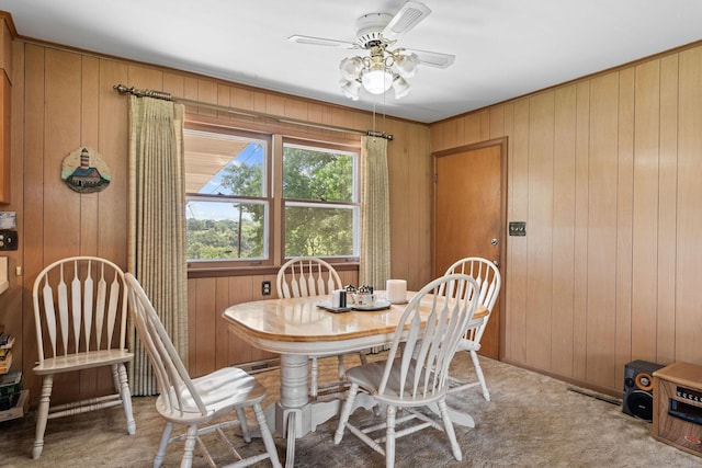 25720 Hillcrest Dr, Shell Knob, MO 65747 - dining room with ceiling fan, wood walls, and carpet floors