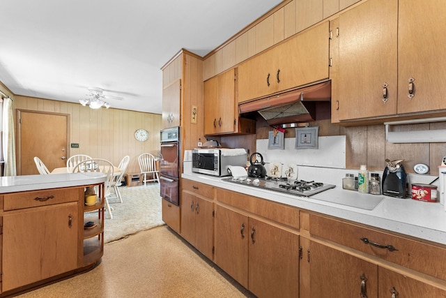 25720 Hillcrest Dr, Shell Knob, MO 65747 - kitchen with stainless steel microwave, white gas cooktop, ventilation hood, oven, and light countertops