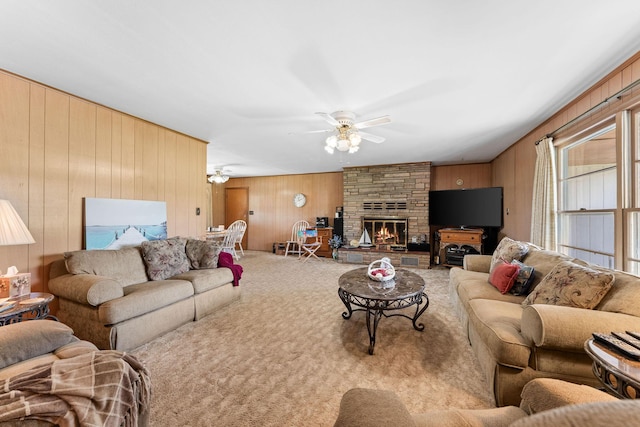 25720 Hillcrest Dr, Shell Knob, MO 65747 - living area with wood walls, a ceiling fan, carpet, and a fireplace