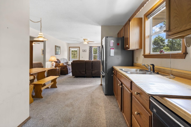 310 Turtle Cove Ln, Reeds Spring, MO 65737 - kitchen featuring open floor plan, light colored carpet, healthy amount of natural light, and brown cabinetry