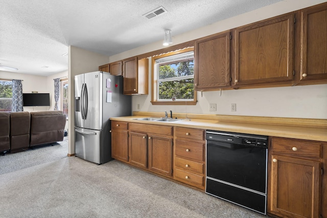310 Turtle Cove Ln, Reeds Spring, MO 65737 - kitchen featuring black dishwasher, stainless steel fridge with ice dispenser, a textured ceiling, brown cabinets, and light countertops