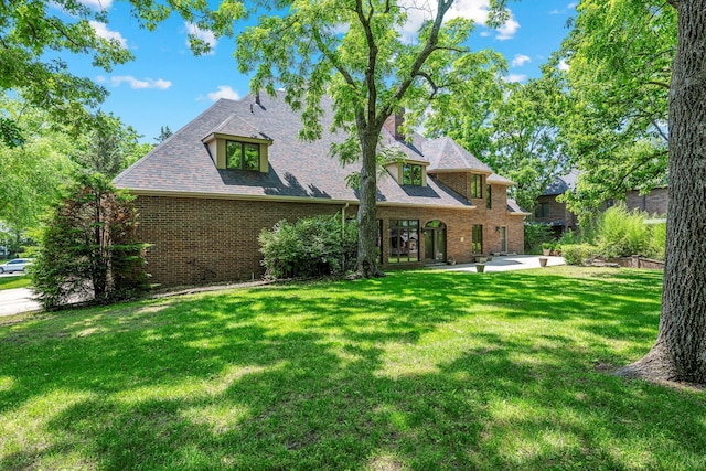 2347 E Nottingham St, Springfield, MO 65804 - rear view of property featuring a patio, a yard, and brick siding