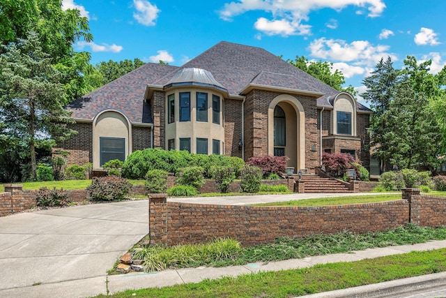 2347 E Nottingham St, Springfield, MO 65804 - french country home with a shingled roof, brick siding, and stucco siding