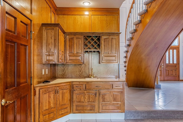 2347 E Nottingham St, Springfield, MO 65804 - kitchen with light countertops, brown cabinets, and light tile patterned flooring