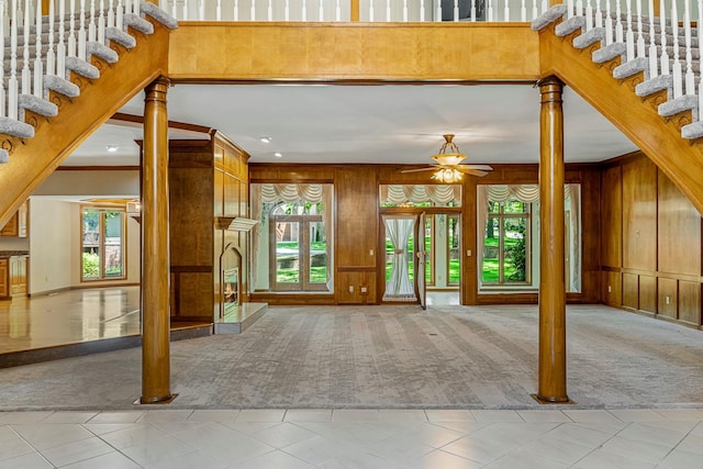 2347 E Nottingham St, Springfield, MO 65804 - carpeted entryway featuring a ceiling fan, wooden walls, stairway, and crown molding