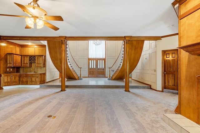 2347 E Nottingham St, Springfield, MO 65804 - unfurnished living room with stairs, a ceiling fan, light colored carpet, and crown molding