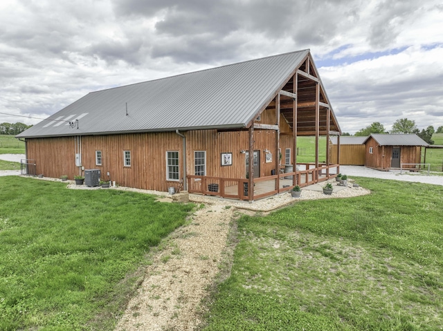 12132 W Farm Road 18, Walnut Grove, MO 65770 - back of house with a yard, a metal roof, and a storage unit