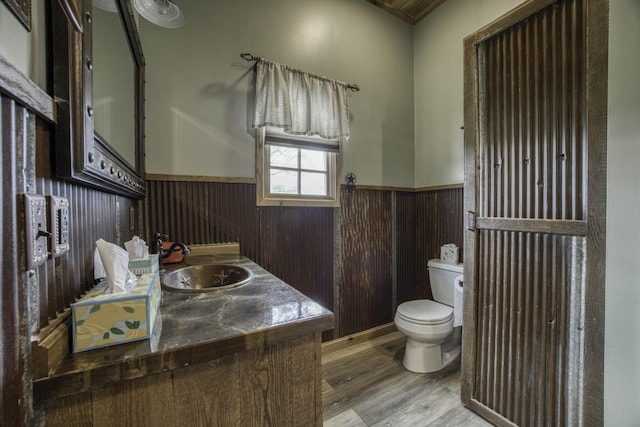 12132 W Farm Road 18, Walnut Grove, MO 65770 - half bath with wainscoting, wood finished floors, vanity, and wooden walls