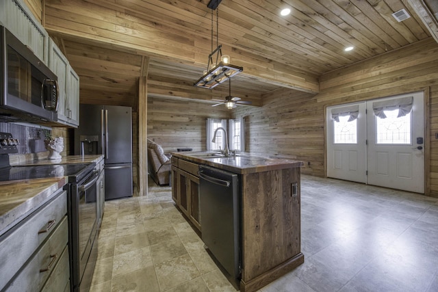 12132 W Farm Road 18, Walnut Grove, MO 65770 - kitchen featuring appliances with stainless steel finishes, wooden walls, wood ceiling, an island with sink, and ceiling fan