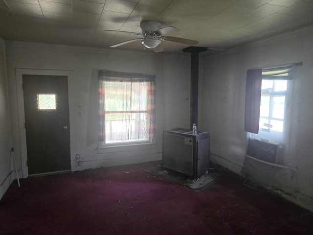 510 W 4th St, Willow Springs, MO 65793 - foyer featuring a wood stove, healthy amount of natural light, a ceiling fan, and ornamental molding
