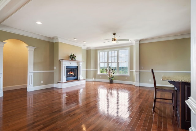 358 Spring View Pl, Reeds Spring, MO 65737 - unfurnished living room with decorative columns, ceiling fan, wood finished floors, a warm lit fireplace, and recessed lighting
