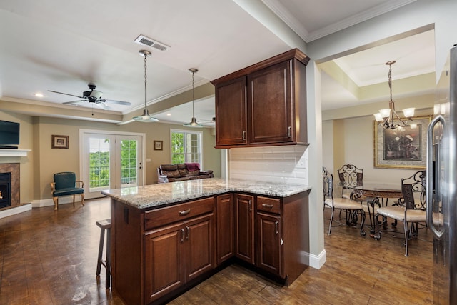 358 Spring View Pl, Reeds Spring, MO 65737 - kitchen featuring open floor plan, a peninsula, stainless steel fridge, a warm lit fireplace, and crown molding