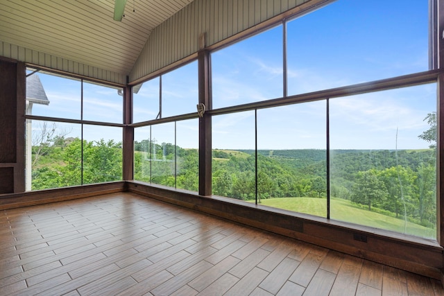 358 Spring View Pl, Reeds Spring, MO 65737 - unfurnished sunroom featuring lofted ceiling, a view of trees, and healthy amount of natural light