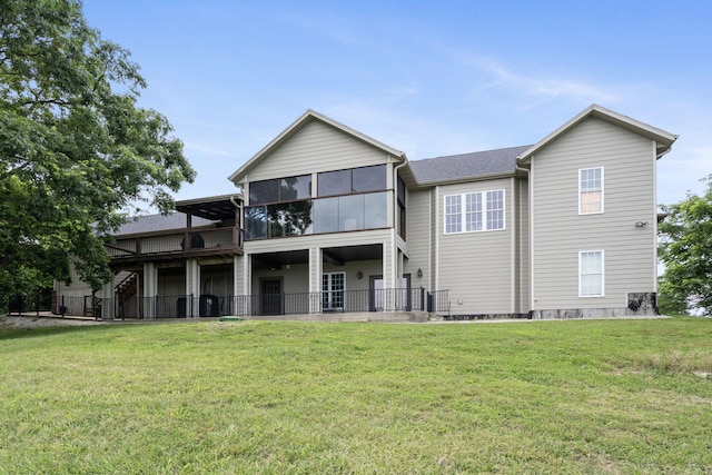 358 Spring View Pl, Reeds Spring, MO 65737 - rear view of property with a sunroom, a lawn, and roof with shingles