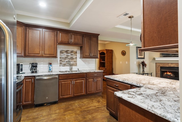 358 Spring View Pl, Reeds Spring, MO 65737 - kitchen featuring appliances with stainless steel finishes, crown molding, backsplash, light stone countertops, and decorative light fixtures