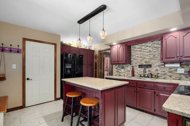 3141 E Raynell St Unit D, Springfield, MO 65804 - kitchen with reddish brown cabinets, a kitchen island, backsplash, and decorative light fixtures