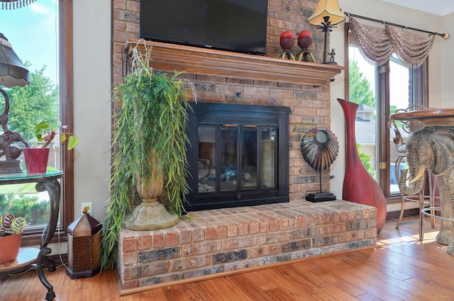 3141 E Raynell St Unit D, Springfield, MO 65804 - detailed view of wood finished floors and a brick fireplace