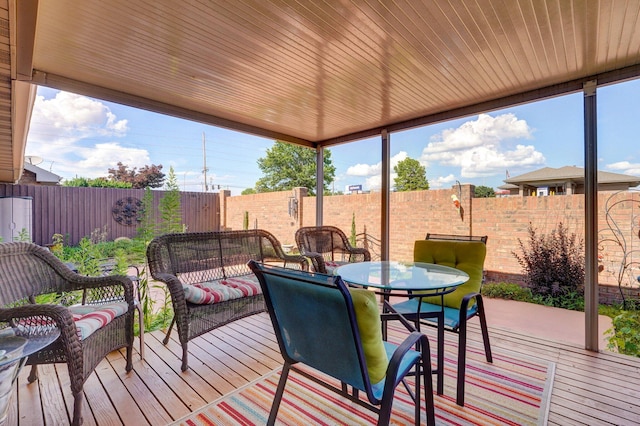 3141 E Raynell St Unit D, Springfield, MO 65804 - wooden terrace featuring a fenced backyard, an outdoor hangout area, and outdoor dining space
