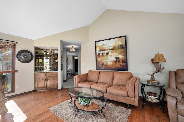 3141 E Raynell St Unit D, Springfield, MO 65804 - living area featuring lofted ceiling and light wood-type flooring