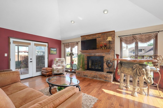 3141 E Raynell St Unit D, Springfield, MO 65804 - living room with french doors, a brick fireplace, wood finished floors, and high vaulted ceiling